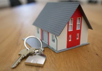 Photo of house keychain and key on a table